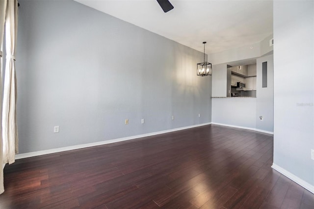 501 S Moody Ave Unit 1134, Tampa, FL 33609 - empty room featuring dark wood-style flooring, a ceiling fan, and a chandelier
