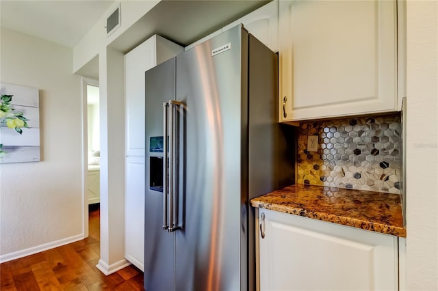 6105 Bahia Del Mar Cir Unit 388, Saint Petersburg, FL 33715 - kitchen featuring high quality fridge, dark wood finished floors, decorative backsplash, and white cabinets