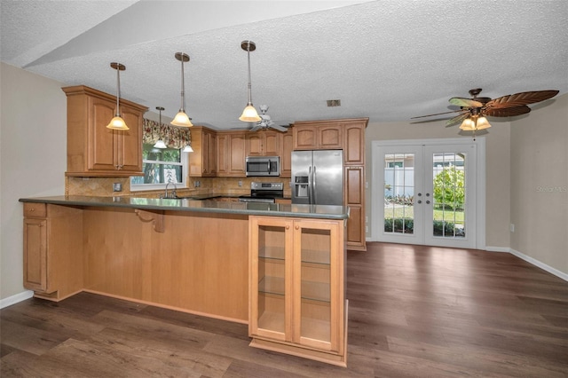 11279 Oakridge Trl, Seminole, FL 33772 - kitchen with stainless steel appliances, tasteful backsplash, french doors, a peninsula, and dark wood finished floors