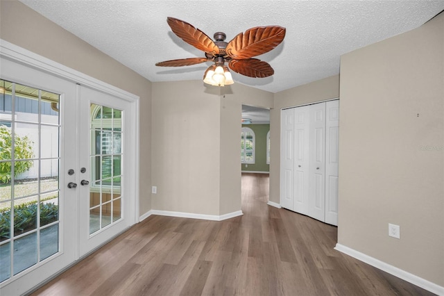 11279 Oakridge Trl, Seminole, FL 33772 - spare room with french doors, wood finished floors, ceiling fan, and a textured ceiling