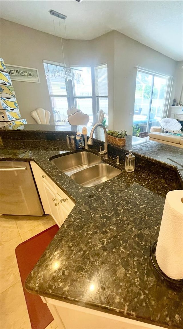 7224 Yardley Way, Tampa, FL 33647 - kitchen featuring stainless steel dishwasher, dark stone countertops, light tile patterned floors, and open floor plan
