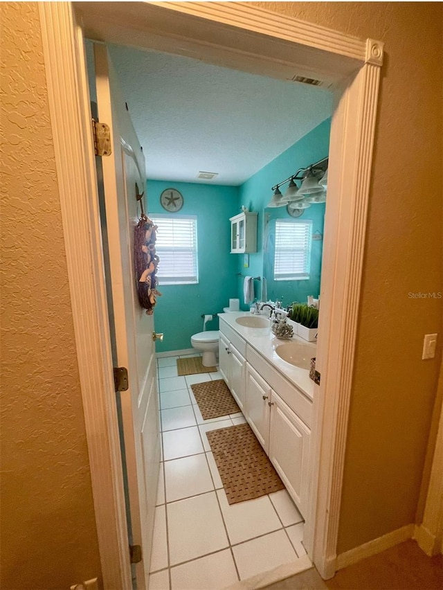 7224 Yardley Way, Tampa, FL 33647 - bathroom featuring a textured wall, double vanity, and tile patterned flooring