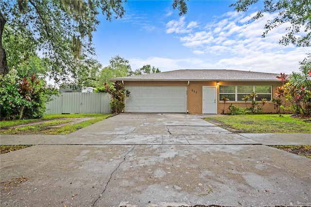 523 Northride Trl, Lakeland, FL 33813 - view of front of property featuring brick siding, an attached garage, driveway, and roof with shingles