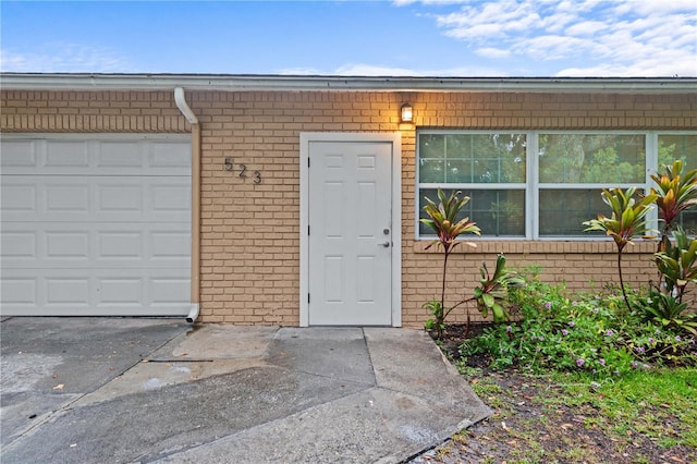 523 Northride Trl, Lakeland, FL 33813 - property entrance featuring brick siding, driveway, and a garage