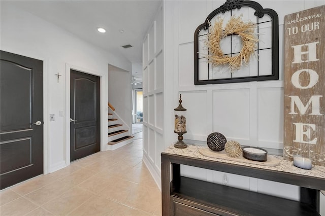 6412 Mayra Shores Ln, Apollo Beach, FL 33572 - hallway featuring a decorative wall, light tile patterned floors, stairs, and recessed lighting