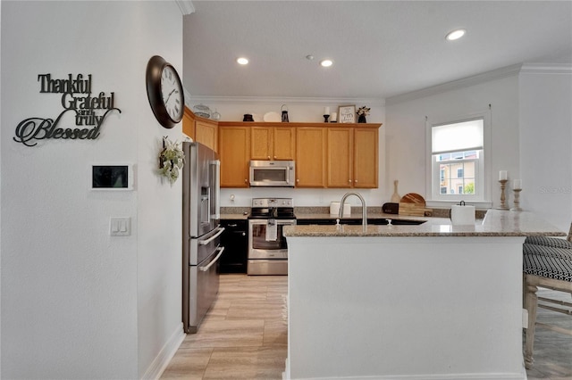 6412 Mayra Shores Ln, Apollo Beach, FL 33572 - kitchen with appliances with stainless steel finishes, crown molding, light stone countertops, recessed lighting, and light wood finished floors