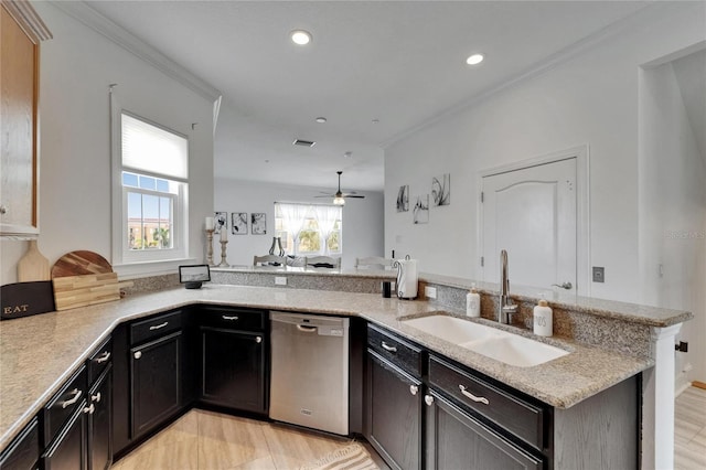 6412 Mayra Shores Ln, Apollo Beach, FL 33572 - kitchen with stainless steel dishwasher, light wood finished floors, a ceiling fan, recessed lighting, and light stone counters