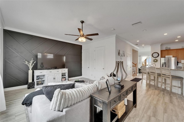 6412 Mayra Shores Ln, Apollo Beach, FL 33572 - living room with a decorative wall, ornamental molding, stairs, ceiling fan, and light wood finished floors