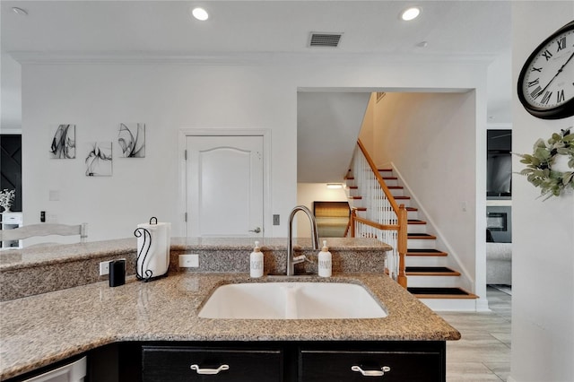 6412 Mayra Shores Ln, Apollo Beach, FL 33572 - kitchen featuring light stone counters, crown molding, dark cabinets, and recessed lighting