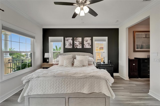 6412 Mayra Shores Ln, Apollo Beach, FL 33572 - bedroom featuring multiple windows, ornamental molding, light wood finished floors, and a ceiling fan