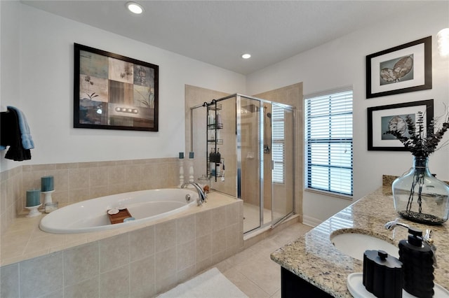 6412 Mayra Shores Ln, Apollo Beach, FL 33572 - bathroom featuring a garden tub, double vanity, a shower stall, tile patterned floors, and recessed lighting