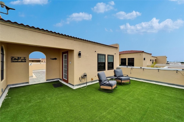 6412 Mayra Shores Ln, Apollo Beach, FL 33572 - rear view of property with a balcony, stucco siding, and a yard
