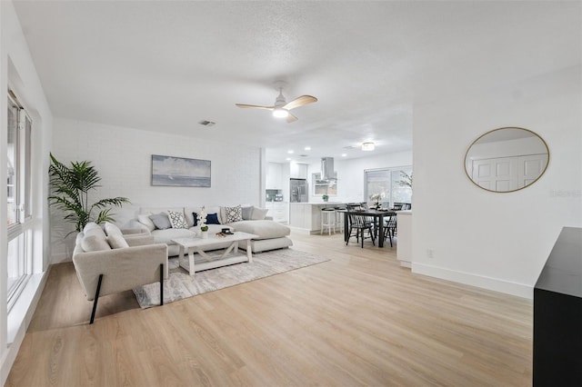 8256 Lark St, Seminole, FL 33777 - living room with light wood-style floors and ceiling fan