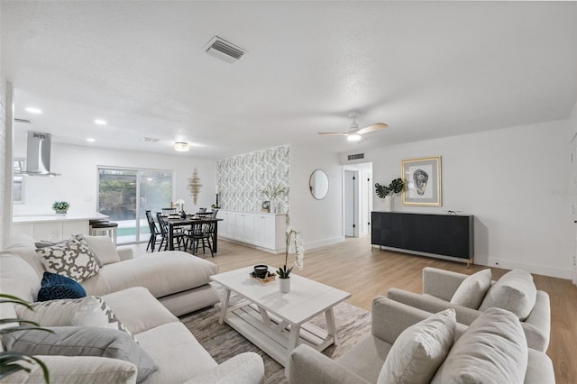 8256 Lark St, Seminole, FL 33777 - living room with light wood-type flooring, a ceiling fan, and recessed lighting