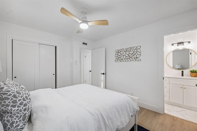 8256 Lark St, Seminole, FL 33777 - bedroom with a closet, connected bathroom, and ceiling fan