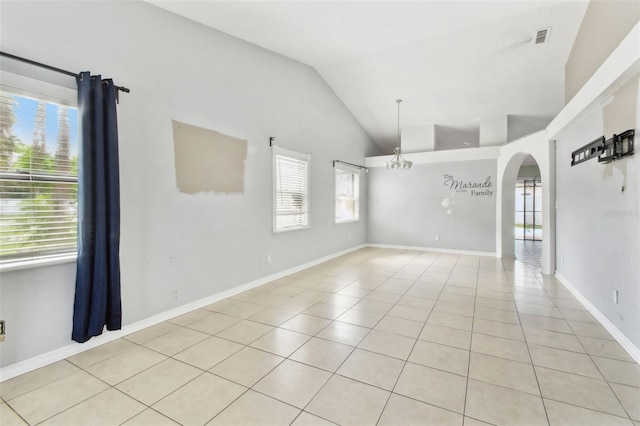 11304 Plumtree Ct, Riverview, FL 33579 - spare room featuring arched walkways, lofted ceiling, healthy amount of natural light, and light tile patterned flooring
