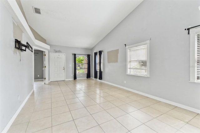 11304 Plumtree Ct, Riverview, FL 33579 - spare room with light tile patterned flooring, high vaulted ceiling, and a barn door
