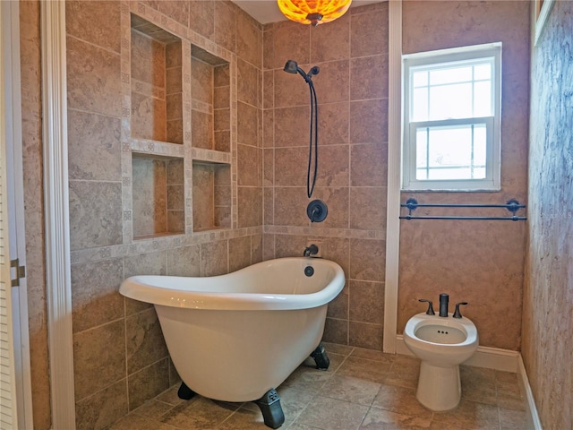 8759 Orient Way NE, Saint Petersburg, FL 33702 - full bathroom with a freestanding tub, a bidet, tile walls, and tile patterned flooring