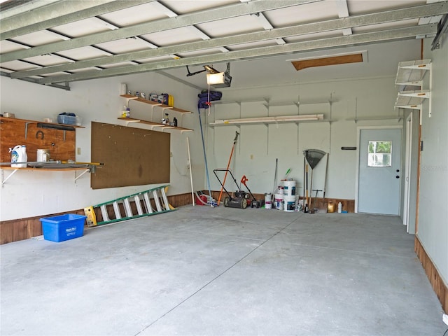 8759 Orient Way NE, Saint Petersburg, FL 33702 - garage with a garage door opener and a workshop area