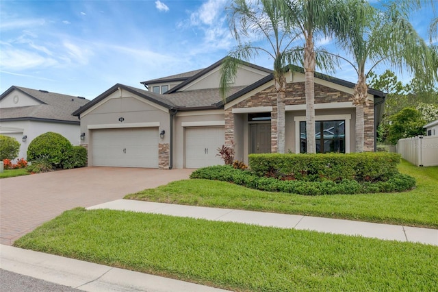 18125 Roseate Dr, Lutz, FL 33558 - view of front of house featuring stone siding, decorative driveway, stucco siding, and an attached garage