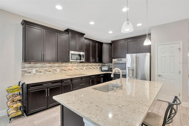 18125 Roseate Dr, Lutz, FL 33558 - kitchen featuring appliances with stainless steel finishes, tasteful backsplash, light stone counters, and recessed lighting