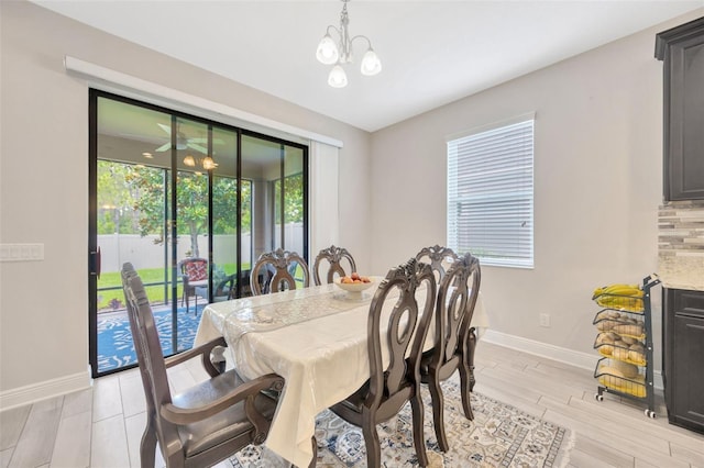 18125 Roseate Dr, Lutz, FL 33558 - dining area with a chandelier and light wood-style flooring