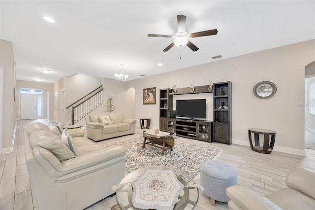 18125 Roseate Dr, Lutz, FL 33558 - living room with arched walkways, stairway, ceiling fan, recessed lighting, and light wood-style floors