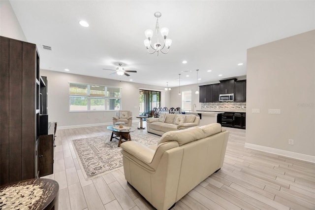 18125 Roseate Dr, Lutz, FL 33558 - living area with a chandelier, a ceiling fan, wood finish floors, and recessed lighting