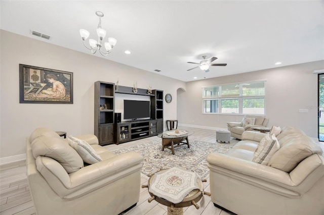 18125 Roseate Dr, Lutz, FL 33558 - living area with arched walkways, ceiling fan, light wood finished floors, recessed lighting, and a chandelier