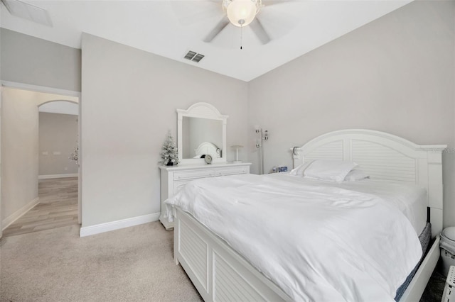 18125 Roseate Dr, Lutz, FL 33558 - bedroom with light carpet, ceiling fan, and arched walkways