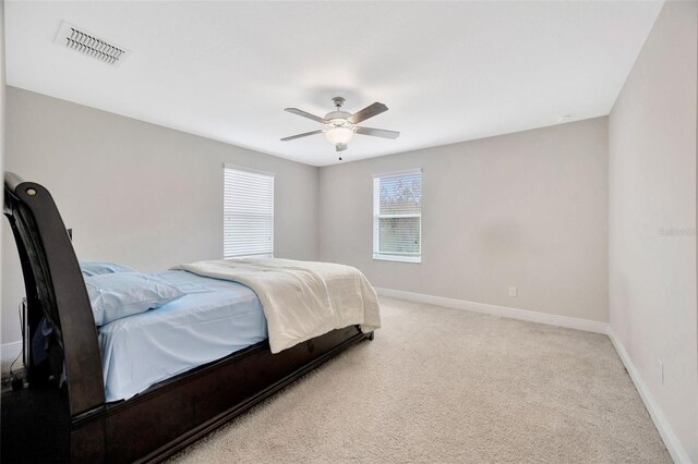 18125 Roseate Dr, Lutz, FL 33558 - bedroom featuring light colored carpet and ceiling fan