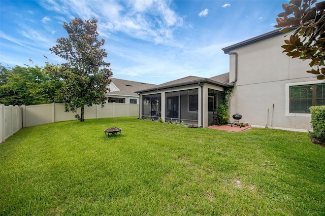 18125 Roseate Dr, Lutz, FL 33558 - fenced backyard with a sunroom and an outdoor fire pit