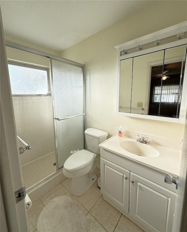 10181 44th Way N Unit 2, Pinellas Park, FL 33782 - full bath with vanity, a shower stall, ceiling fan, tile patterned floors, and a textured wall