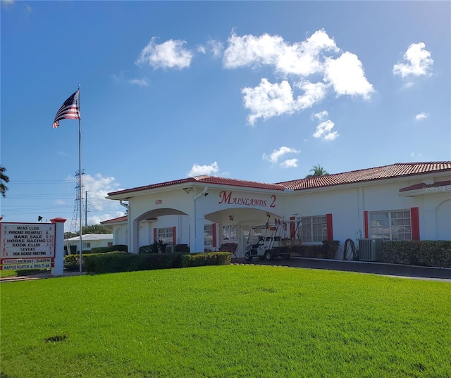 10181 44th Way N Unit 2, Pinellas Park, FL 33782 - view of front of home with a front yard, stucco siding, and a tiled roof
