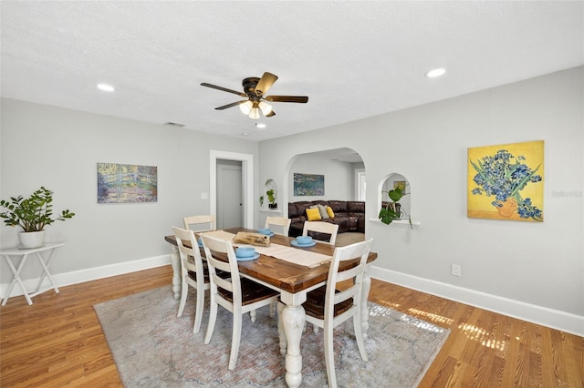 4820 8th Ave S, Saint Petersburg, FL 33711 - dining area featuring arched walkways, light wood finished floors, ceiling fan, and recessed lighting