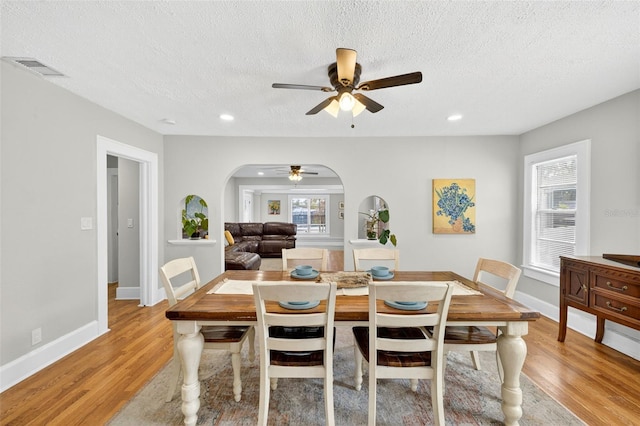 4820 8th Ave S, Saint Petersburg, FL 33711 - dining area featuring arched walkways, a ceiling fan, light wood-type flooring, a textured ceiling, and recessed lighting