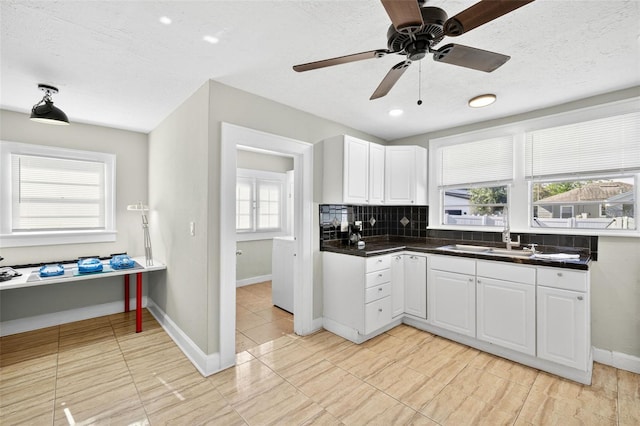 4820 8th Ave S, Saint Petersburg, FL 33711 - kitchen featuring white cabinetry, dark countertops, a ceiling fan, tasteful backsplash, and a textured ceiling