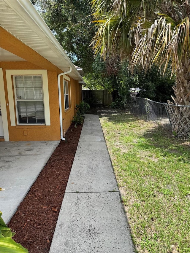 3407 E Comanche Ave, Tampa, FL 33610 - fenced backyard featuring a patio
