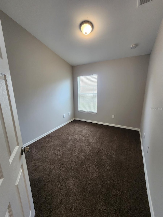 3407 E Comanche Ave, Tampa, FL 33610 - spare room featuring dark colored carpet and a smoke detector