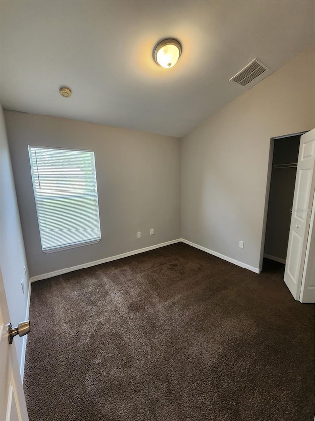 3407 E Comanche Ave, Tampa, FL 33610 - empty room featuring dark carpet and a smoke detector