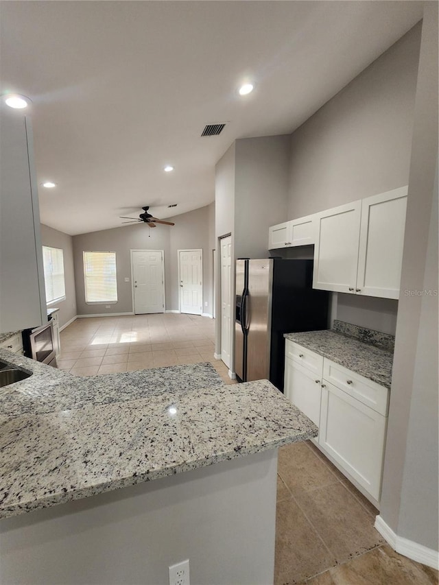 3407 E Comanche Ave, Tampa, FL 33610 - kitchen featuring light tile patterned flooring, stainless steel fridge with ice dispenser, light stone countertops, white cabinetry, and a ceiling fan