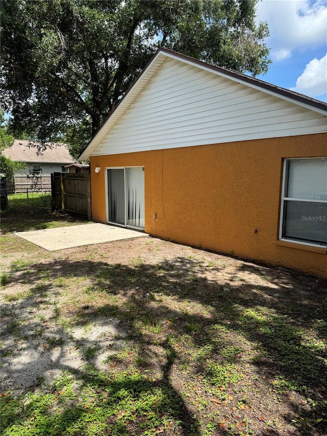 3407 E Comanche Ave, Tampa, FL 33610 - view of side of property featuring a patio and stucco siding