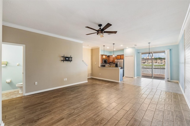 12039 Greengate Dr, Hudson, FL 34669 - unfurnished living room with a ceiling fan, crown molding, wood finished floors, a chandelier, and recessed lighting