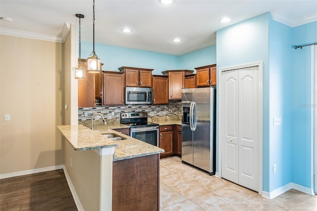 12039 Greengate Dr, Hudson, FL 34669 - kitchen with appliances with stainless steel finishes, a peninsula, brown cabinets, ornamental molding, and light stone countertops