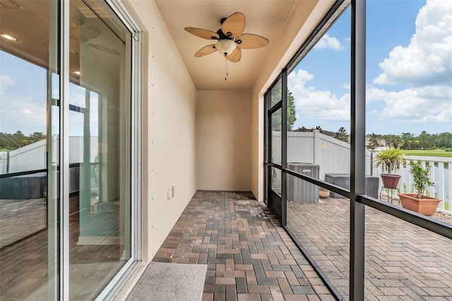 12039 Greengate Dr, Hudson, FL 34669 - unfurnished sunroom featuring ceiling fan and brick floors