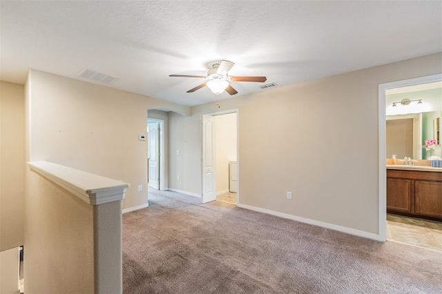 12039 Greengate Dr, Hudson, FL 34669 - spare room featuring a ceiling fan, light colored carpet, and arched walkways