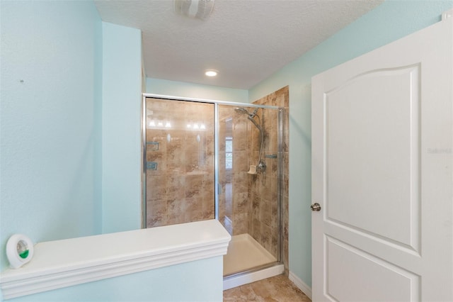 12039 Greengate Dr, Hudson, FL 34669 - bathroom featuring a shower stall and a textured ceiling