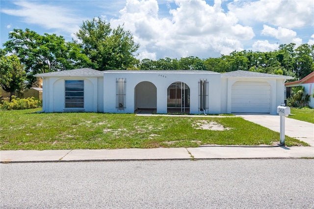 3406 Rock Royal Dr, Holiday, FL 34691 - view of front of home featuring a front lawn, stucco siding, driveway, and a garage