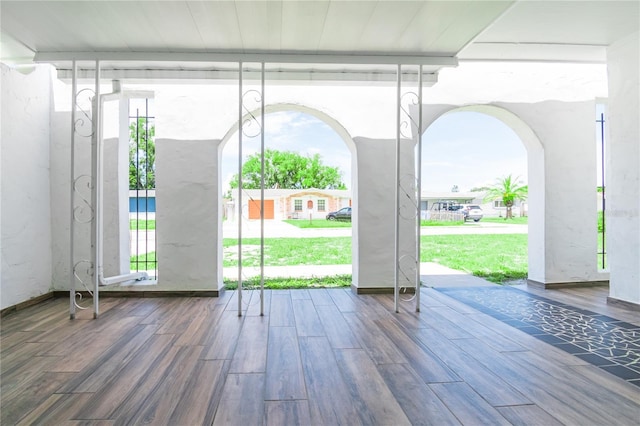 3406 Rock Royal Dr, Holiday, FL 34691 - doorway to outside featuring wood finished floors and arched walkways