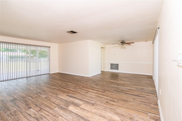 3406 Rock Royal Dr, Holiday, FL 34691 - unfurnished living room featuring wood finished floors and ceiling fan